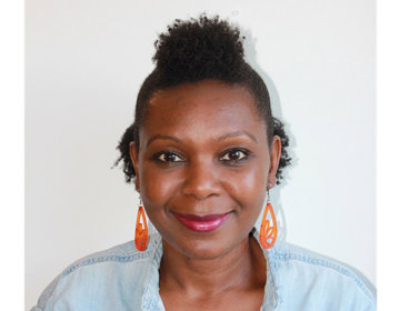 Headshot photo of Sylvia Theuri.