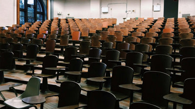 Lecture room with empty wooden seats.
