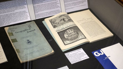Display of historic materials including printed journal volumes.