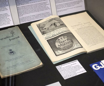 Display of historic materials including printed journal volumes.