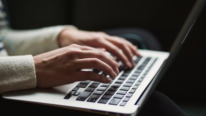A person typing on a laptop