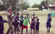 Preet in South Sudan while working with the British Army, playing with kids outside and making paper airplanes. 