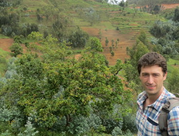 Photo showing Nathan with eucalyptus growing in Rwanda