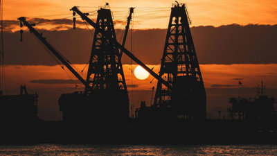 Industrial machinery with a sunset background