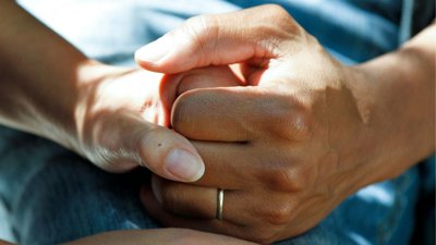 Hands holding each other.