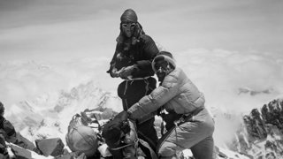 Old black and white photograph of Tenzing Norgay and Edmund Hillary on Everest.