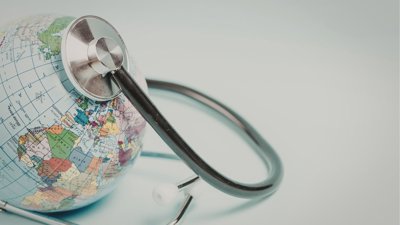Global health care concept with stethoscope on world globe.