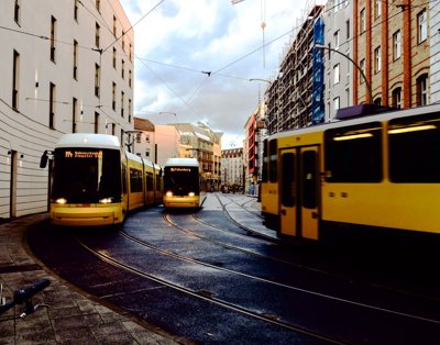 Yellow tams drive along tram tracks 