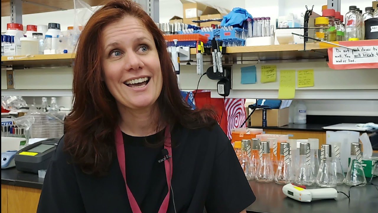 A photograph of Hazel Barton in a laboratory.