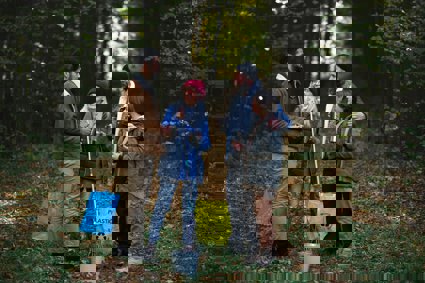 A group of volunteers clearing rubbish in a forest