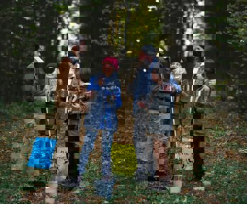 A group of volunteers clearing rubbish in a forest