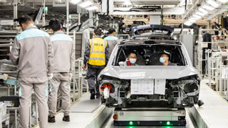 People working on the car production line for Chinese manufacturer Gorya.