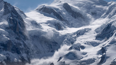 Landscape photography of an avalanche happening on a mountain.
