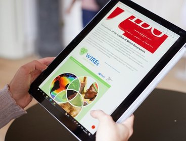 Person looking at online journals on tablet device