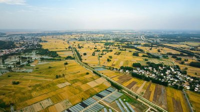 Aerial view of patchwork farmland with a road and small villages