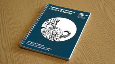 A copy of Expedition Field Techniques: Camera Trapping on a desk.