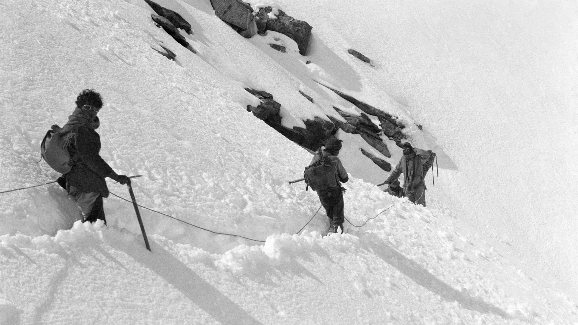 Historical black and white photograph of climbers on Everest.