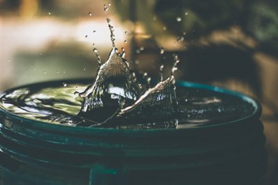 Water splashes up whilst sitting in a plastic bucket