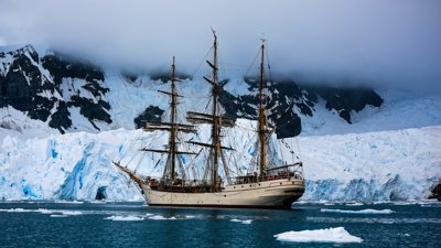 Ship at sea surrounded by ice
