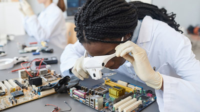 Engineer inspecting computer parts in a quality control lab.