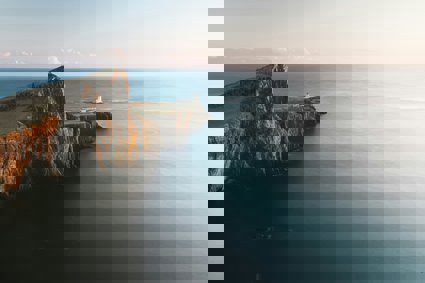 Brown cliffs with lighthouse