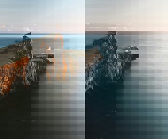 Brown cliffs with lighthouse