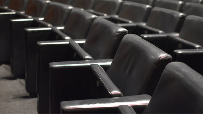 A row of leather chairs in a lecture theatre.