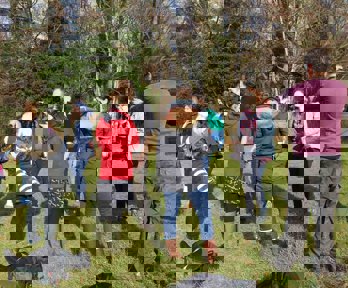 Group of teachers in a field sketching what they can see.