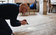 A person looks at an old map with a torch as part of a conservation project.