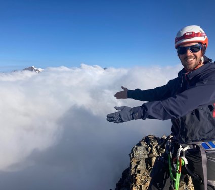 Felix de Montety above the clouds atop a mountain