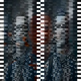 Aleks Vladimirov against a dark foresty background.