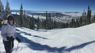 Susan Smith on a snowy mountain in full skiing gear.