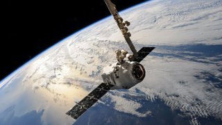 A satellite in space facing Earth.