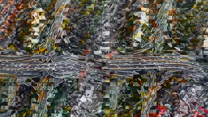 An aerial view of a busy interchange highway in a big city.