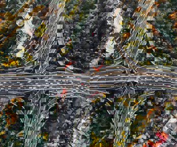 An aerial view of a busy interchange highway in a big city.