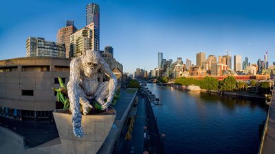 Ape structure on top of building next to city skyline.