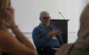 Peter Hopkins speaking into a microphone.