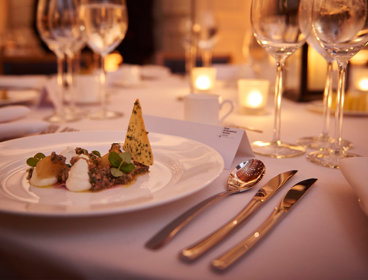 A close-up shot of a dinner table on a formal dinner table.