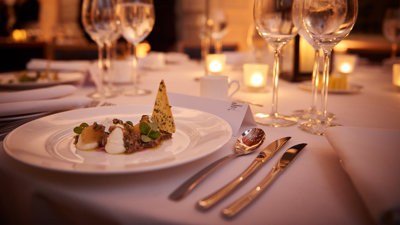 A close-up shot of a dinner table on a formal dinner table.