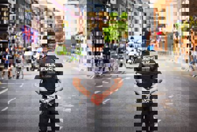 A policeman with his back to camera on a city street