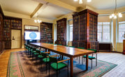A grand historical meeting room with a large boardroom table. 