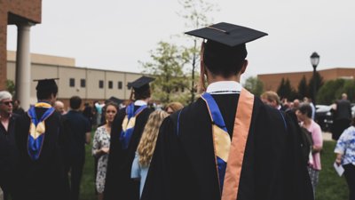 Graduating university students in caps and gowns 