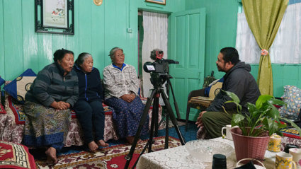 Three people being interviewed and recorded.