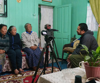 Three people being interviewed and recorded.