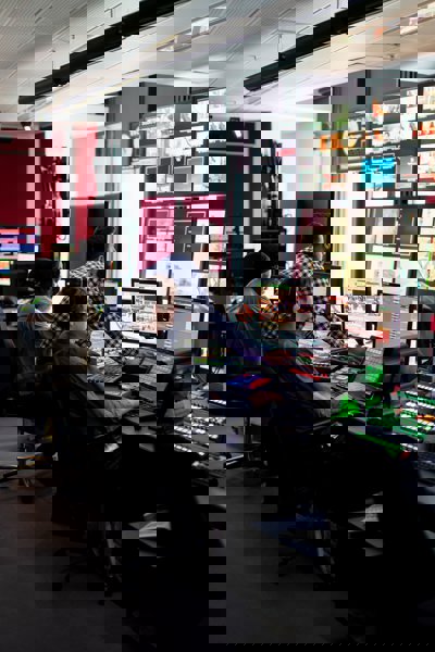 People looking at a bank of TV screens