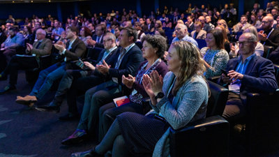 Audience attending a conference applauding.