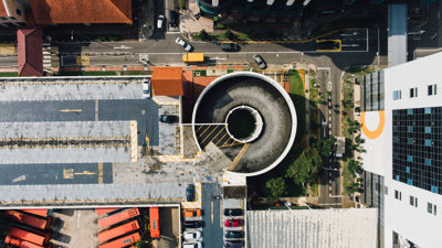 Buildings and roads with traffic in Bishan Singapore seen directly from above.