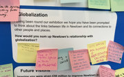 Exhibition board on globalization covered with sticky notes with community views.