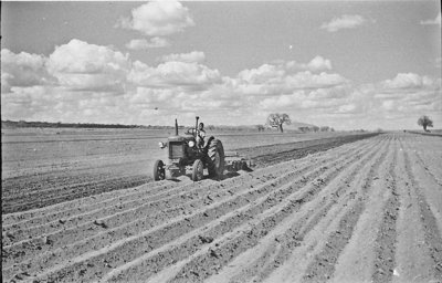 An old impage of a tractor ploughing a field