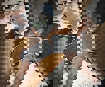 A group of people use maps on their phones